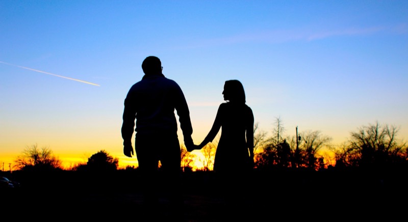 Couple silhouetted at sunset