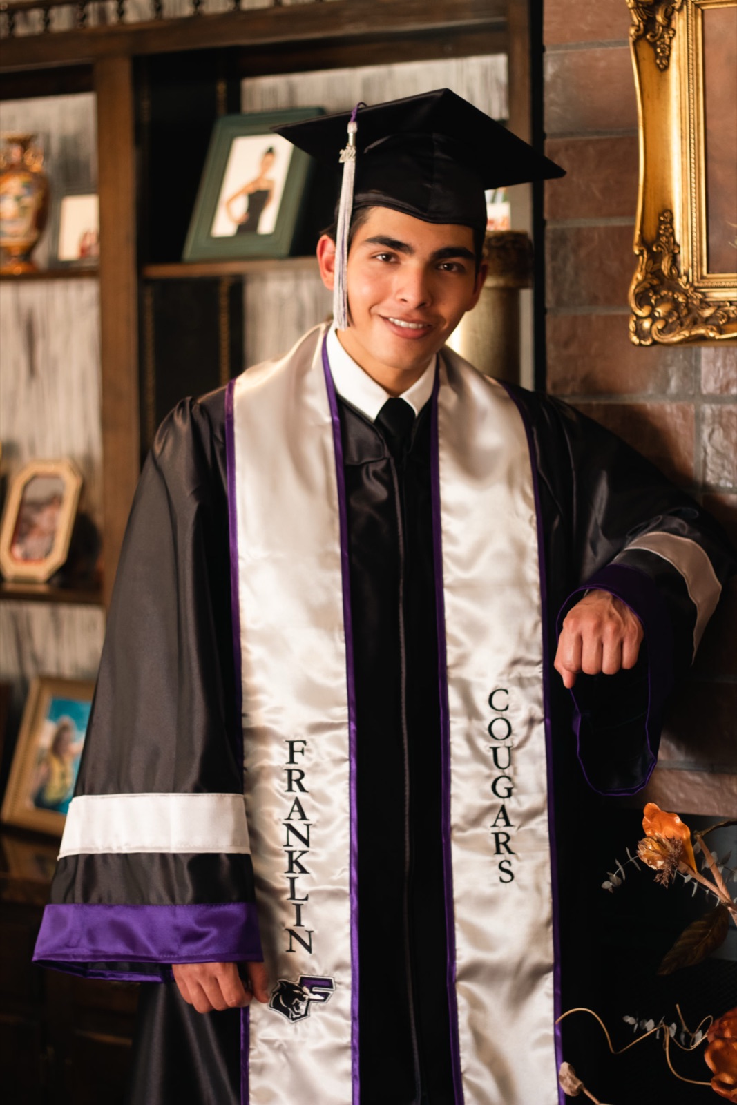 Graduate at golden hour in cap and stole