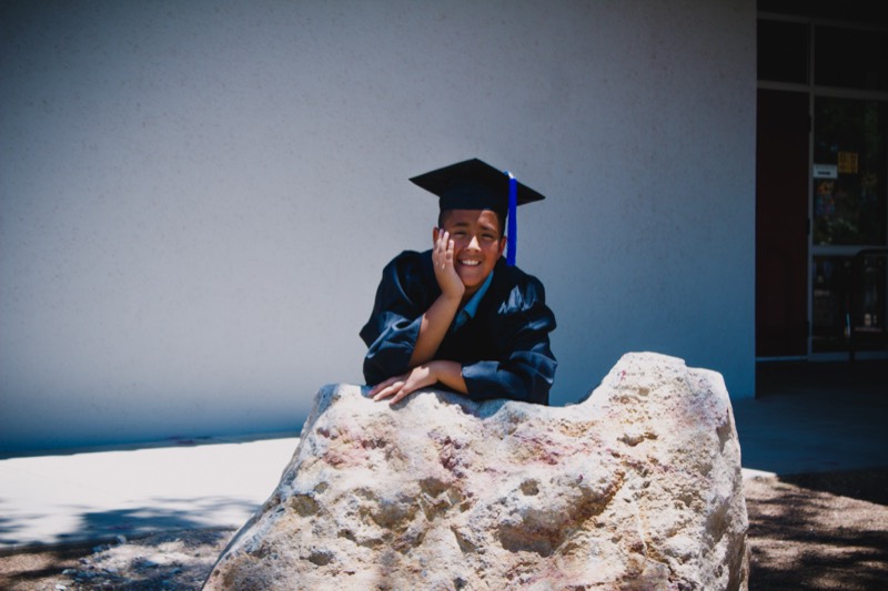 Graduate on a couch with balloons