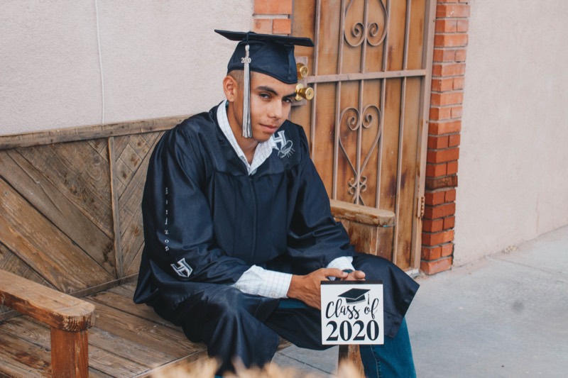 Graduate seated in a navy gown