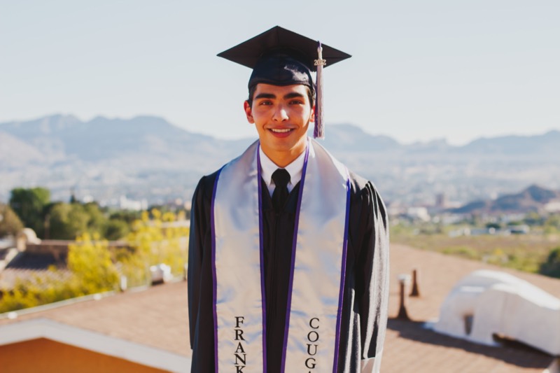 Graduate in a white stole at sunset