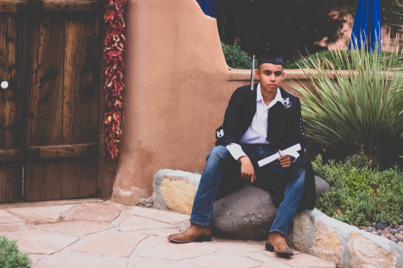 Portrait beside an adobe wall
