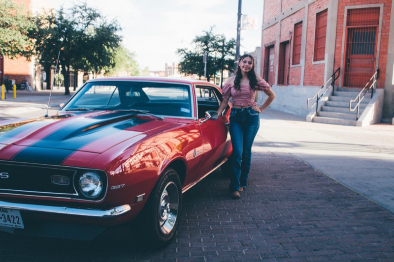 Portrait with a red classic car