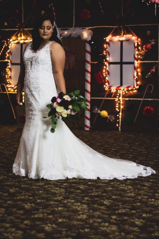 Bride and groom at night among string lights