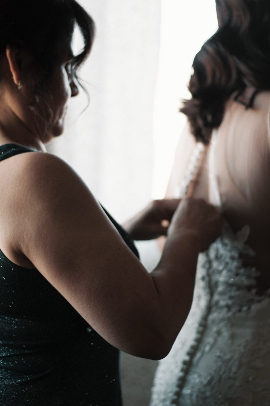 Bride in soft window light on her wedding morning, photographed by K&M
