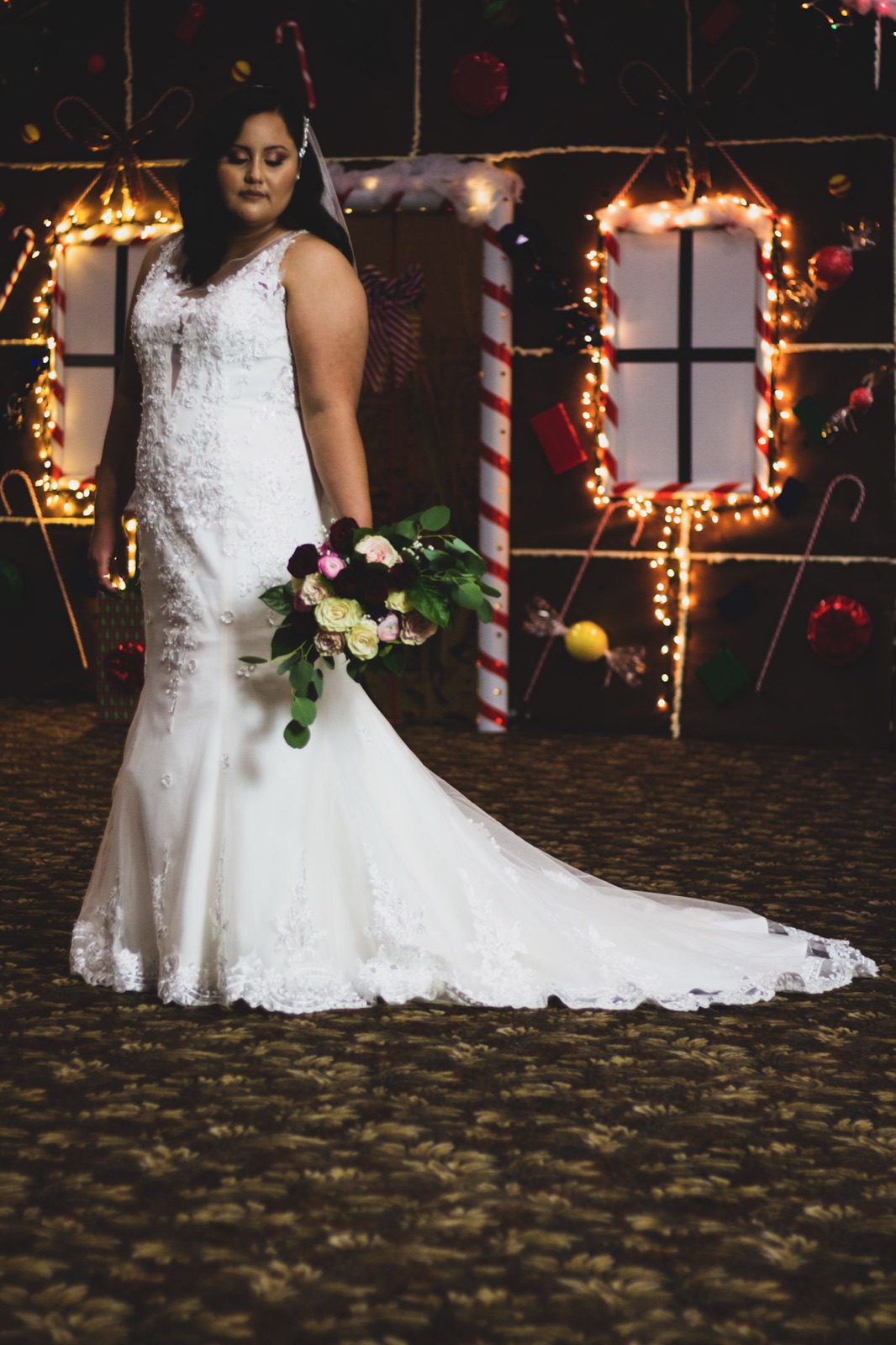 Bride and groom at night among string lights